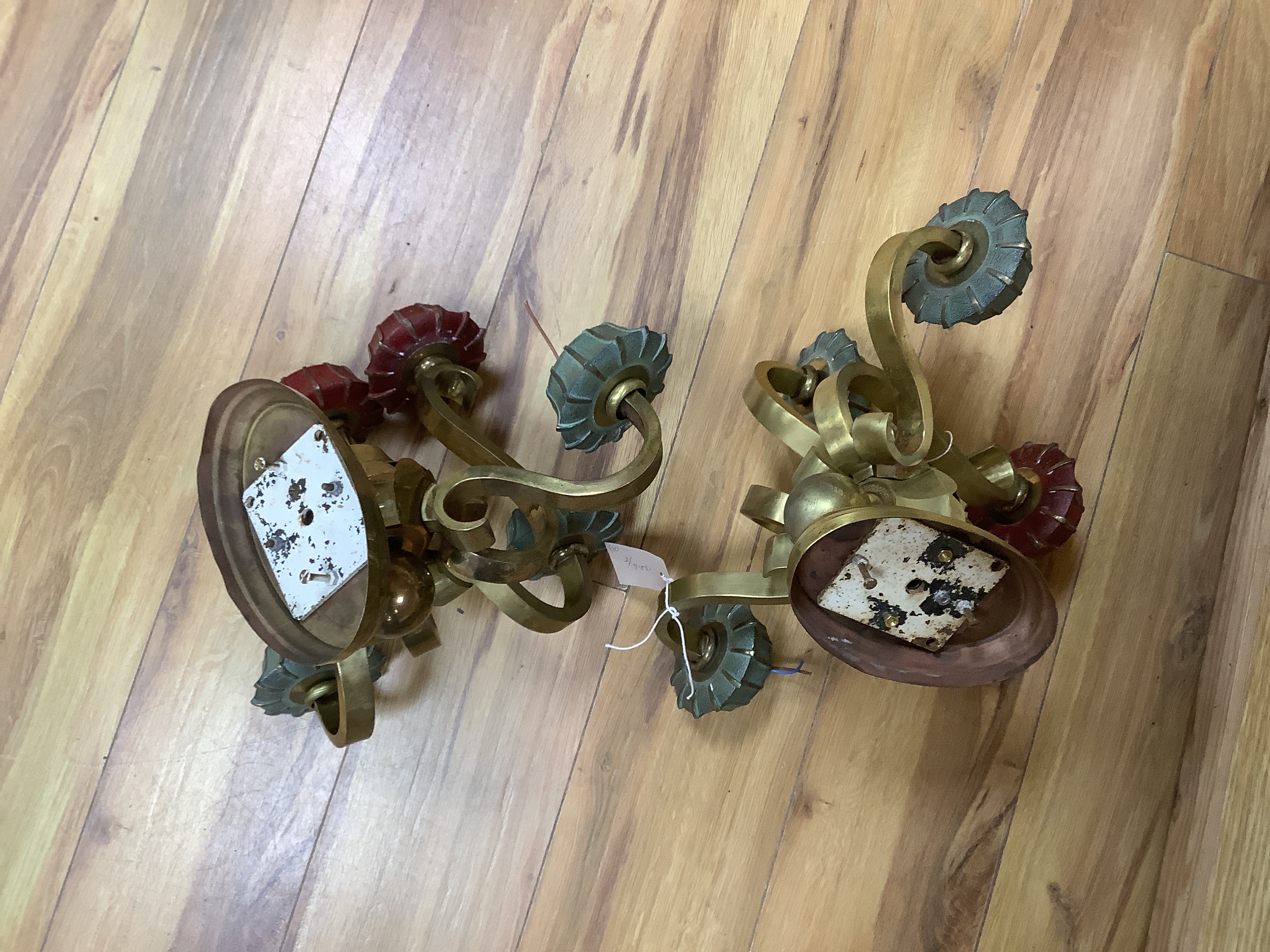 A pair of brass five branch wall lights